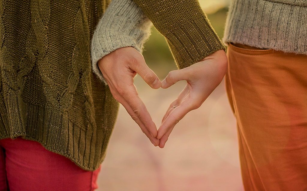 A couple holding hands. How to Save Money & stay Happily Married. WealthyWellthy.com