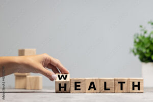 Female hand fliping wooden cubes with word wealth to health. Copyspace for ad, offer.