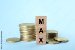 Wooden cubes with word Max and coins on light blue background